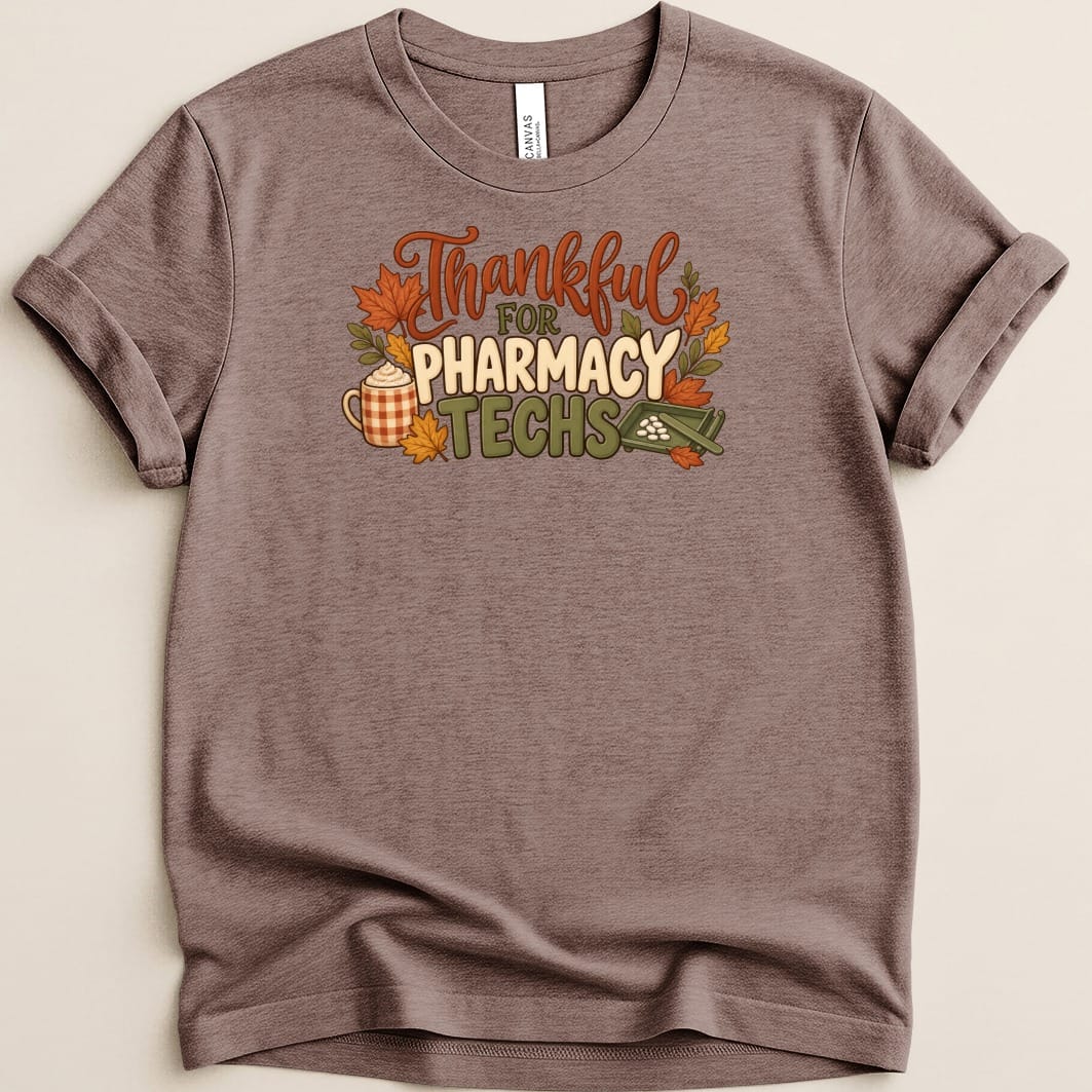 A mauve short-sleeve t-shirt with autumn-themed graphics and text reading Thankful for Pharmacy Techs.