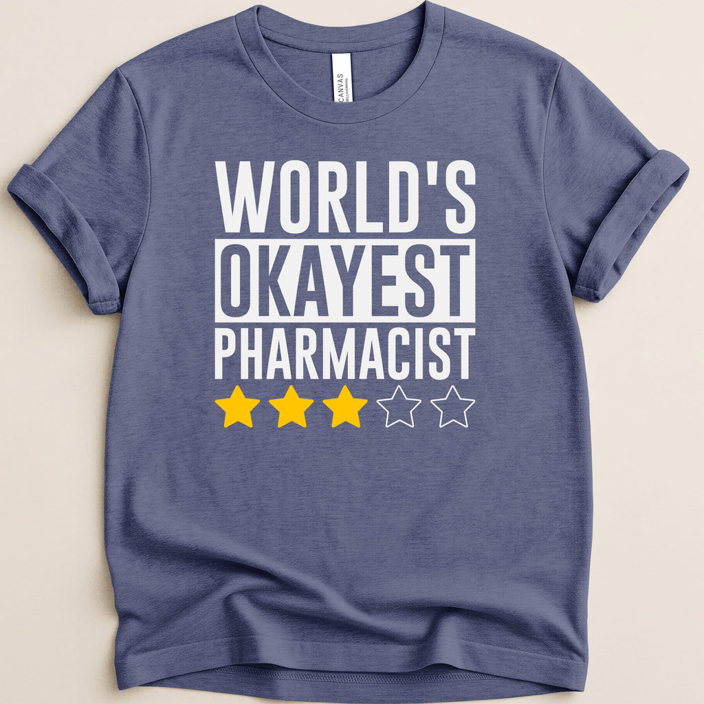 Navy t-shirt with white text reading "WORLD'S OKAYEST PHARMACIST" and three yellow stars.