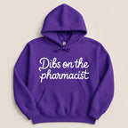 Purple hoodie with white text "Dibs on the pharmacist".