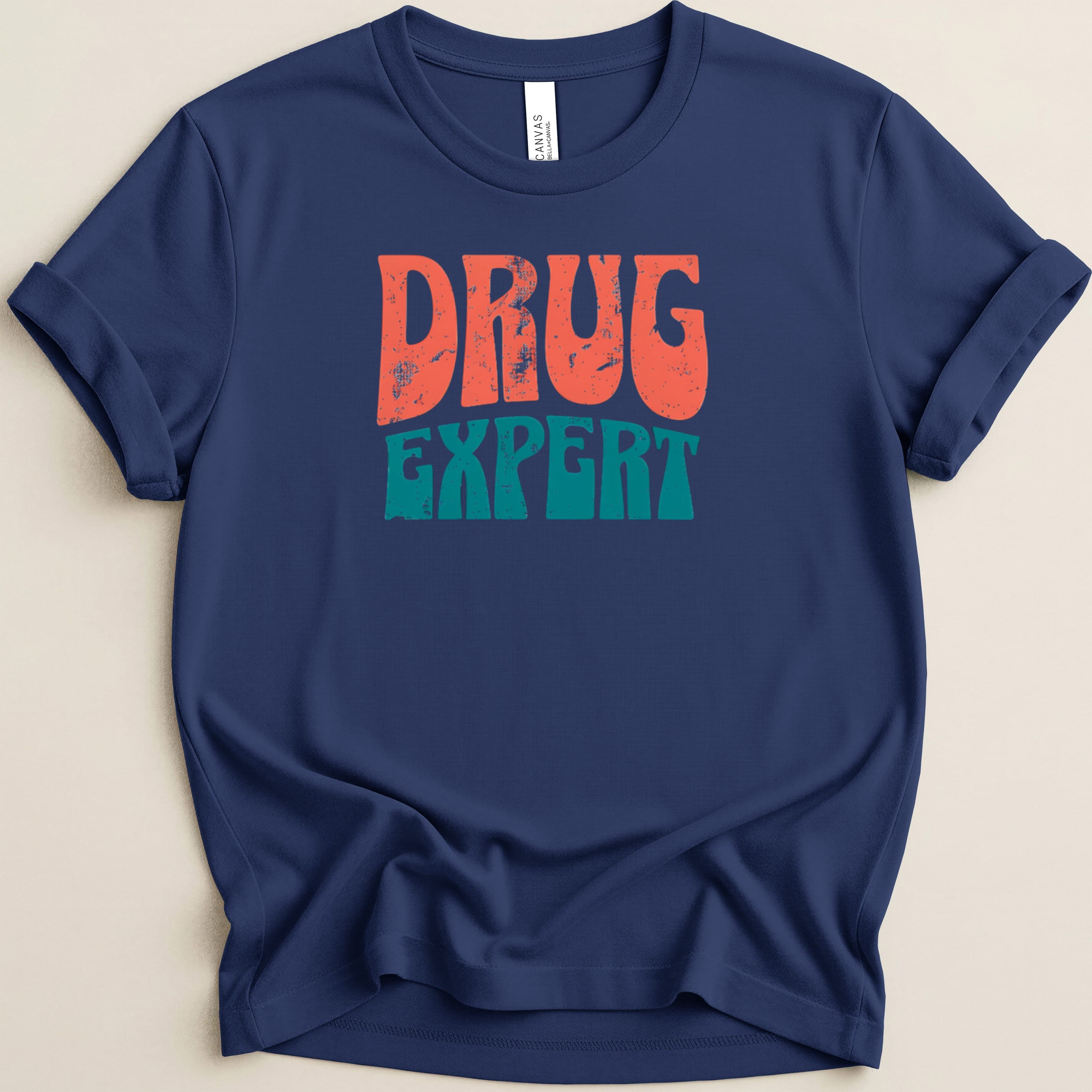 Navy t-shirt with "DRUG EXPERT" in retro orange and teal lettering.