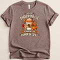 Brown t-shirt with graphic: Pharmacist running on pumpkin spice with coffee cup and fall leaves.
