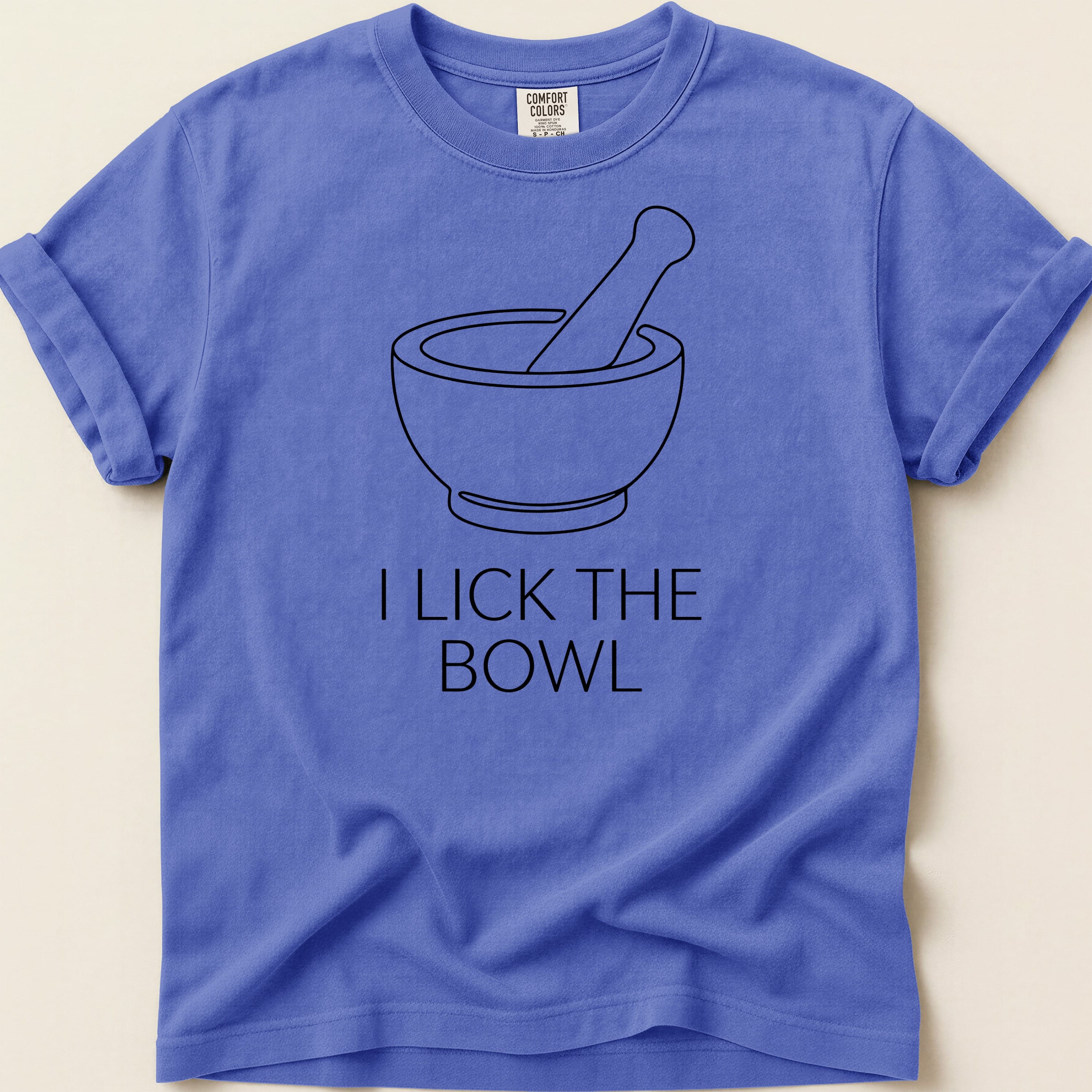 Purple t-shirt with a mortar and pestle graphic and the text "I LICK THE BOWL".