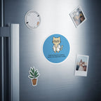 Circular magnet with a cartoon cat wearing glasses and stating "pharmacologically speaking, I exhibit time-dependent toxicity."