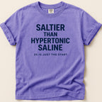 Purple t-shirt with "SALTIER THAN HYPERTONIC SALINE 3% IS JUST THE START" text.