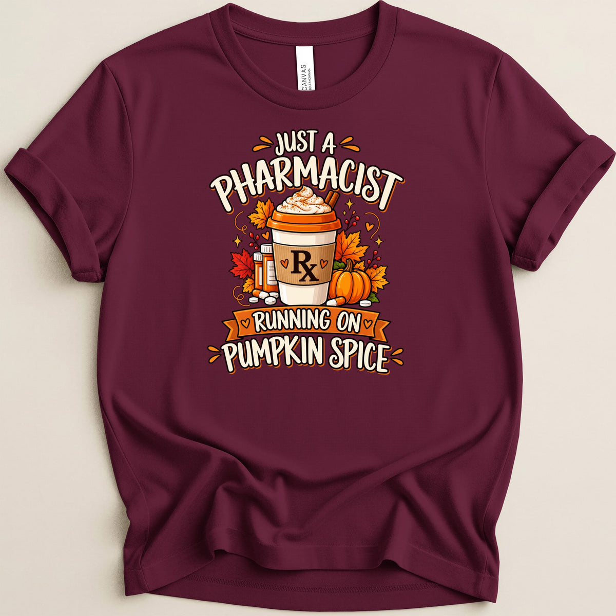 Maroon t-shirt with "Just a Pharmacist Running on Pumpkin Spice" text and fall graphics.