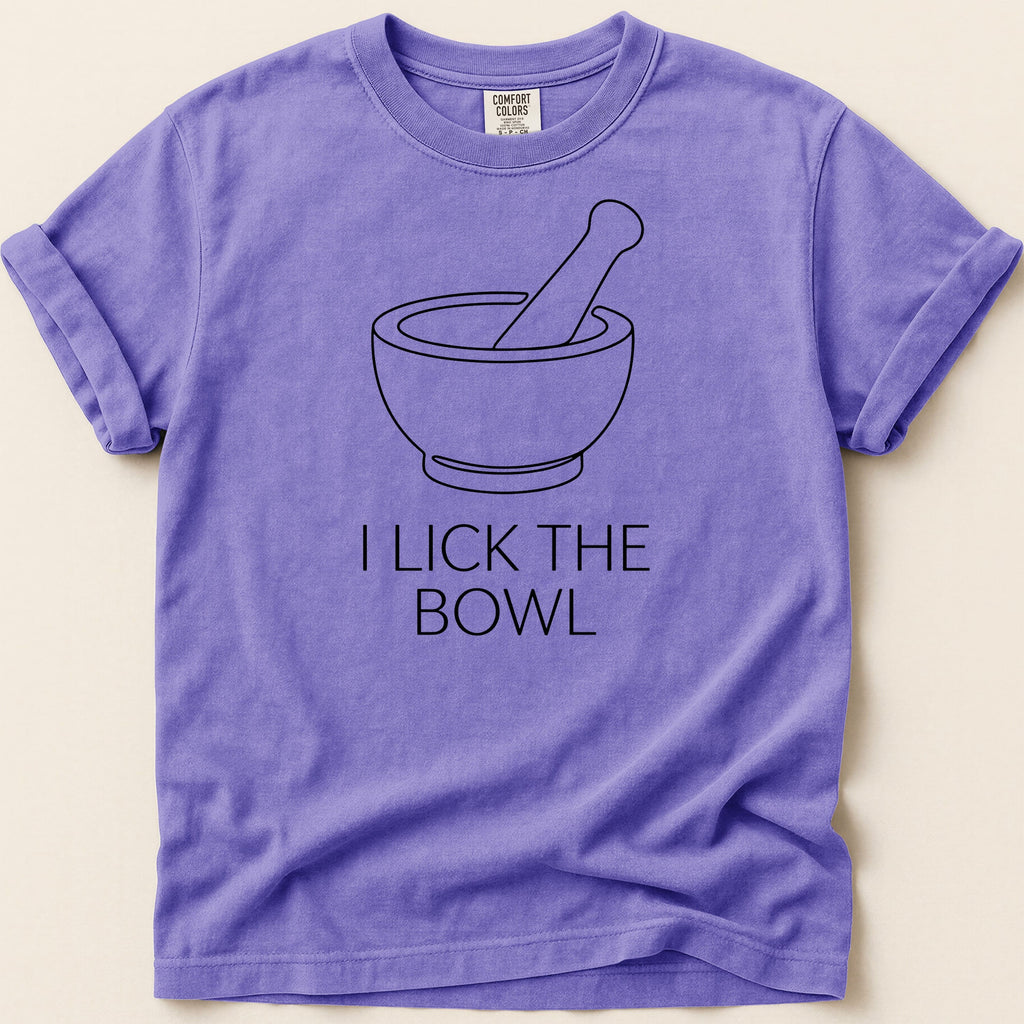 Purple t-shirt with a bowl and pestle graphic and "I LICK THE BOWL" text.