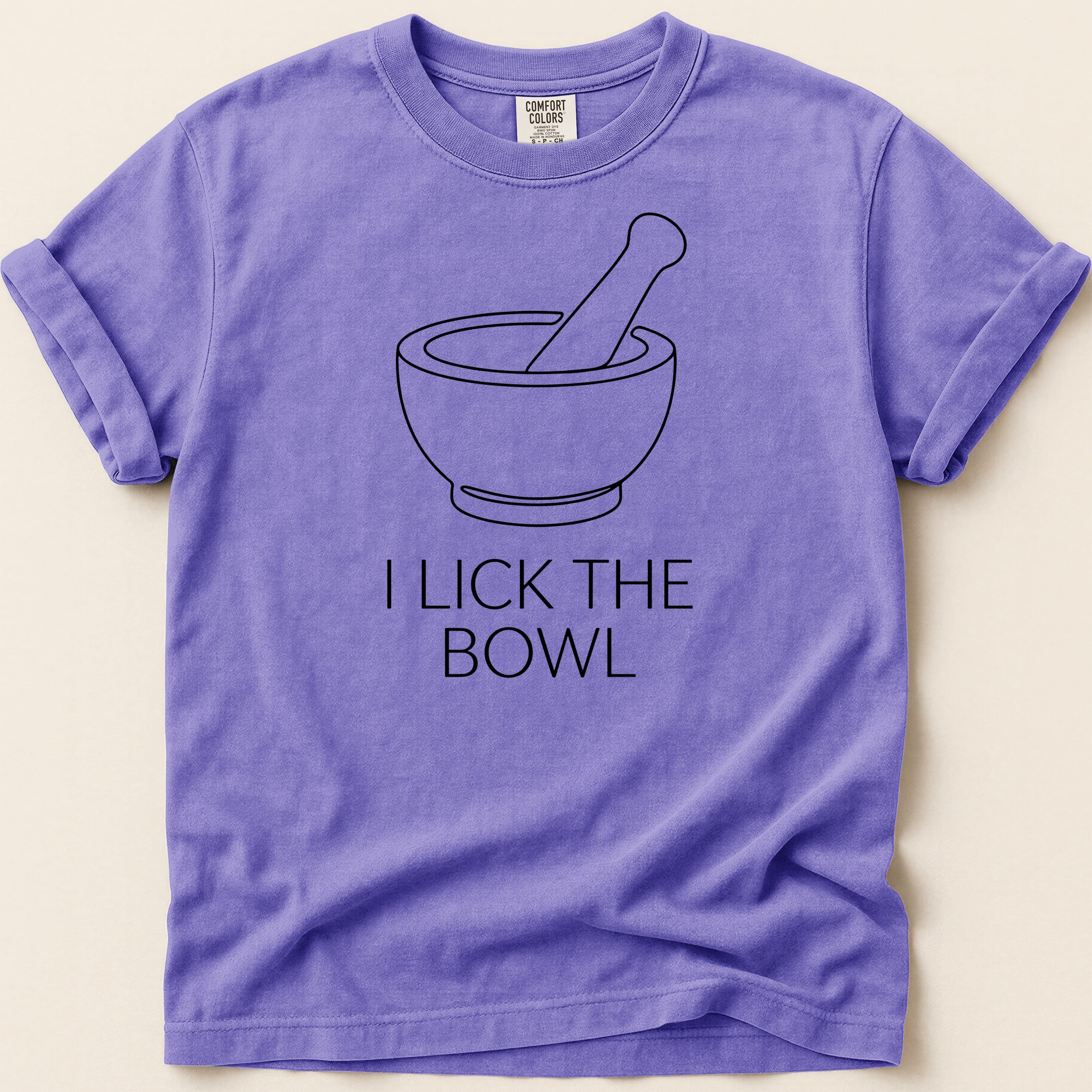 Purple t-shirt with a bowl and pestle graphic and "I LICK THE BOWL" text.