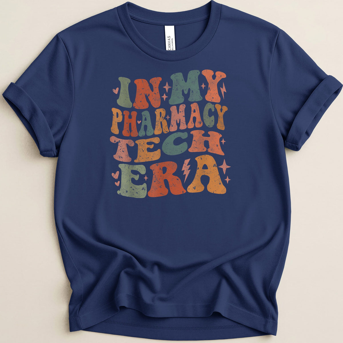 Navy t-shirt with "In My Pharmacy Tech Era" text in retro style.