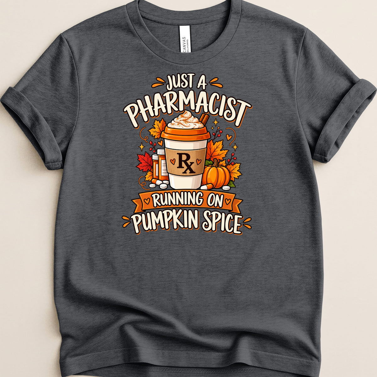 Dark grey t-shirt featuring a pumpkin spice latte graphic with "Just a Pharmacist Running on Pumpkin Spice" text.