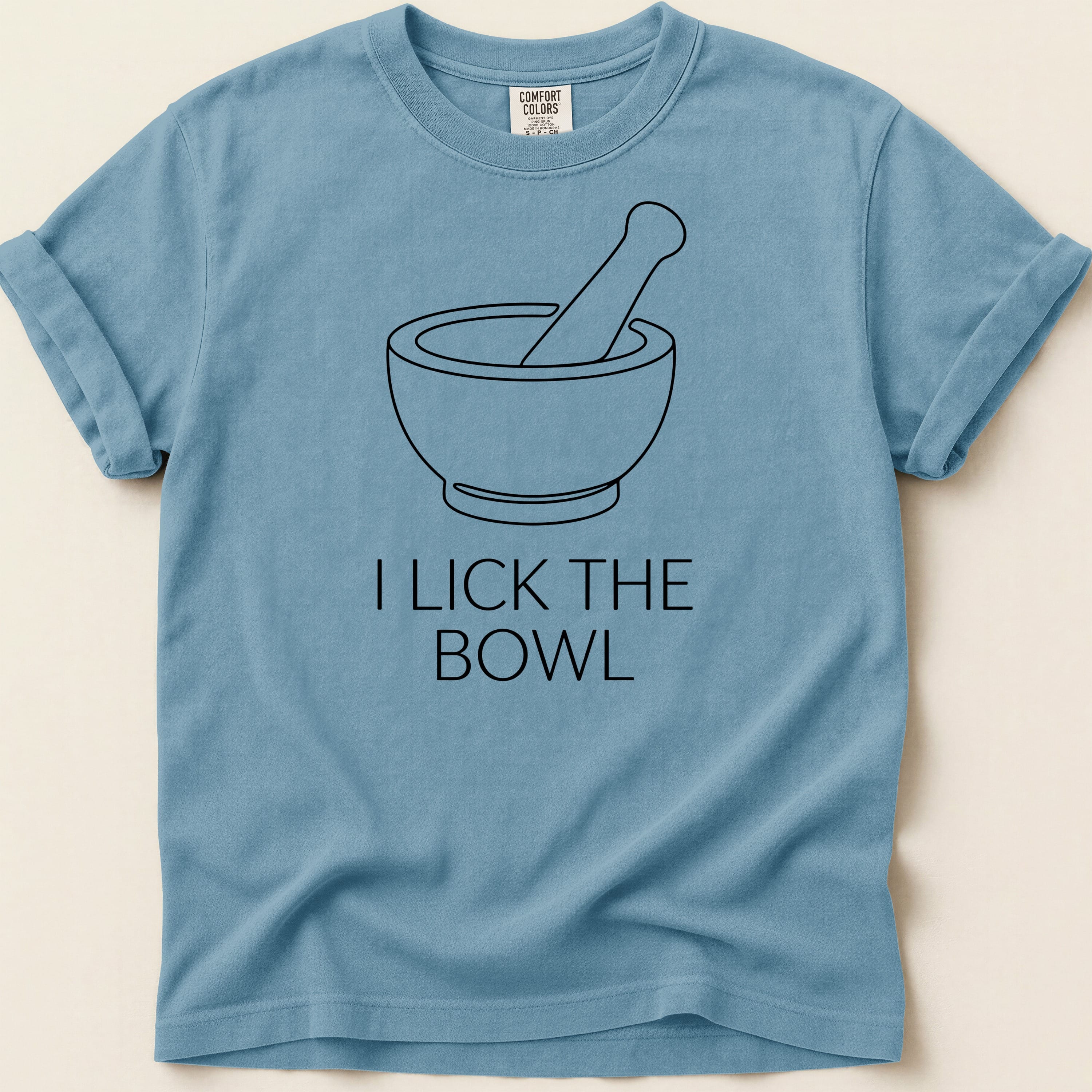 Blue t-shirt with a mortar and pestle graphic and "I lick the bowl" text.