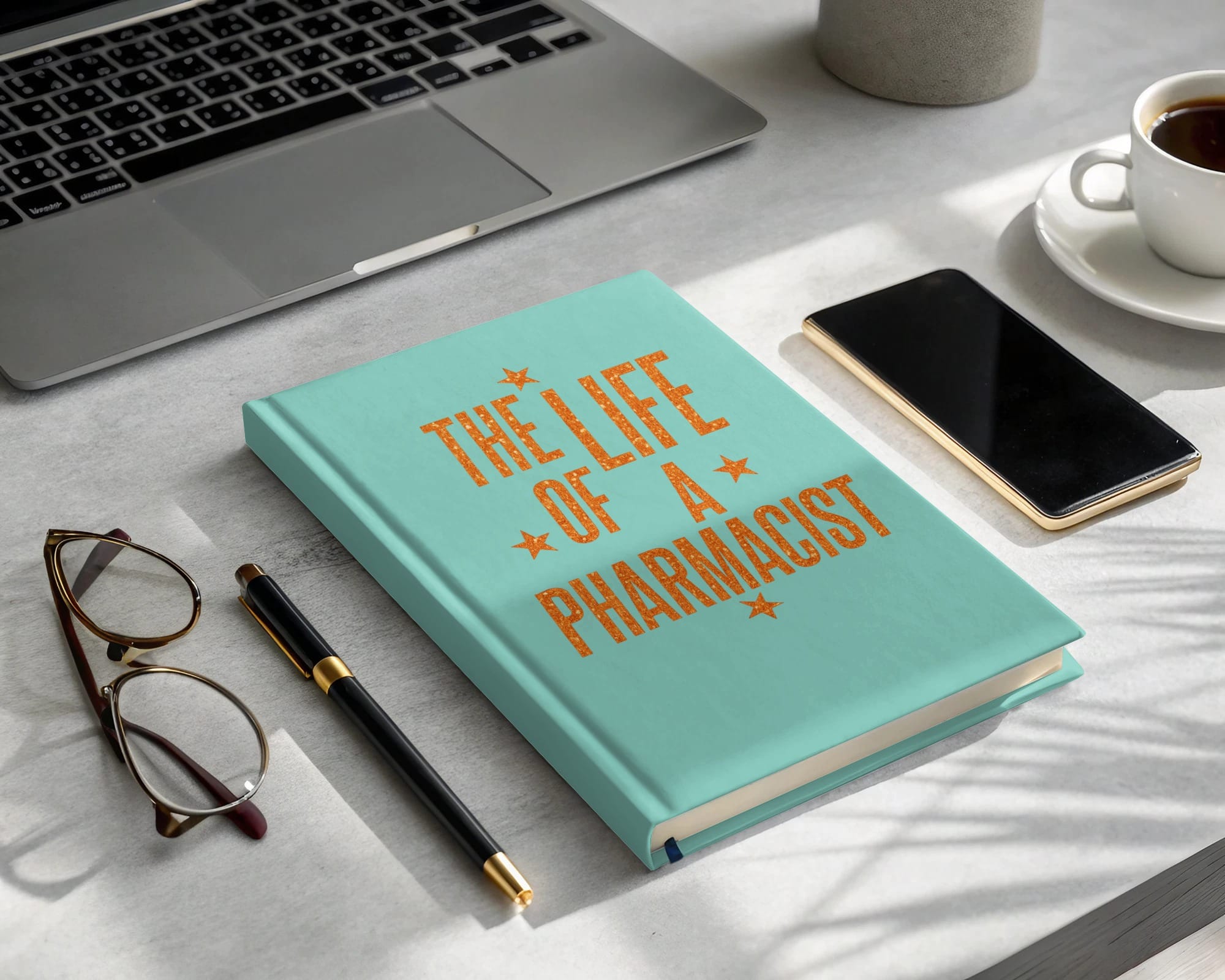 Turquoise planner titled "The Life of a Pharmacist" with glasses, pen, phone, and laptop.