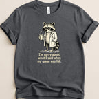 T-shirt featuring a raccoon in a lab coat holding a coffee cup with text.