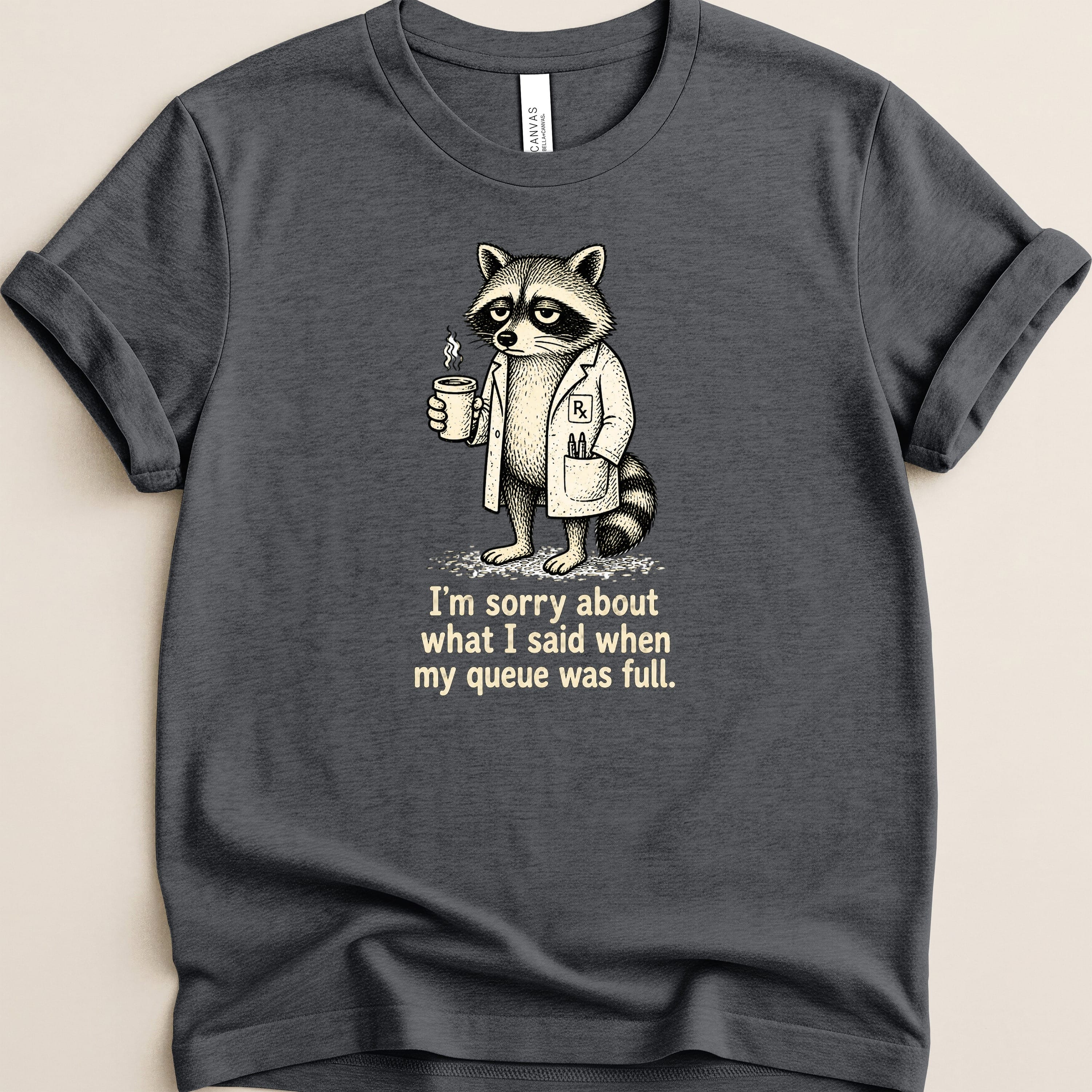 T-shirt featuring a raccoon in a lab coat holding a coffee cup with text.