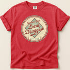 Red t-shirt with circular "Support Your Local Druggist EST. 1920" graphic.