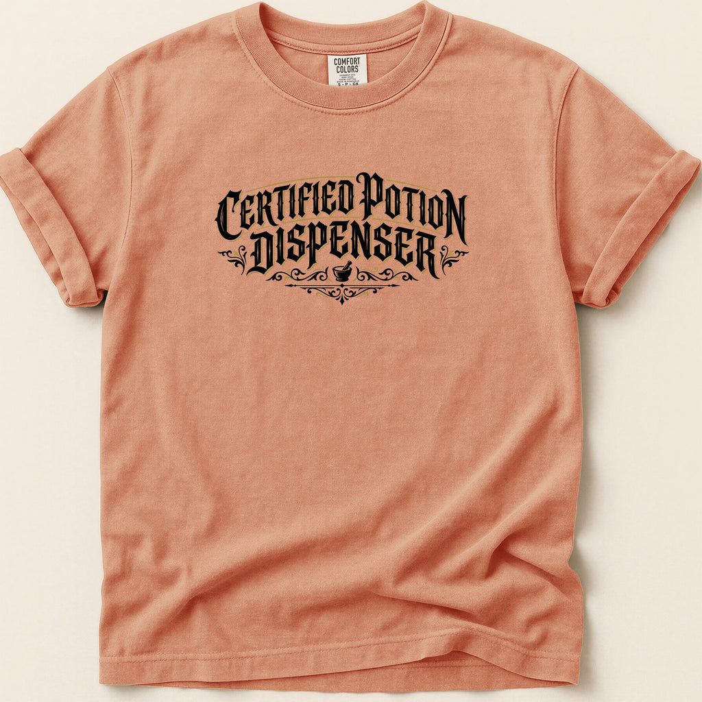 Peach t-shirt with black "Certified Potion Dispenser" text and decorative elements.