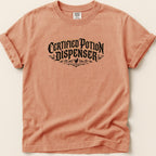 Peach t-shirt with black "Certified Potion Dispenser" text and decorative elements.