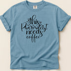 Blue t-shirt with "This Pharmacist Needs Coffee" text in black script.