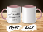 Two mugs with "ANTI ANTIBIOTIC RESISTANCE CLUB" text and pink handles.