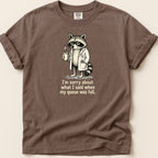 T-shirt with a raccoon in a lab coat holding coffee and text.