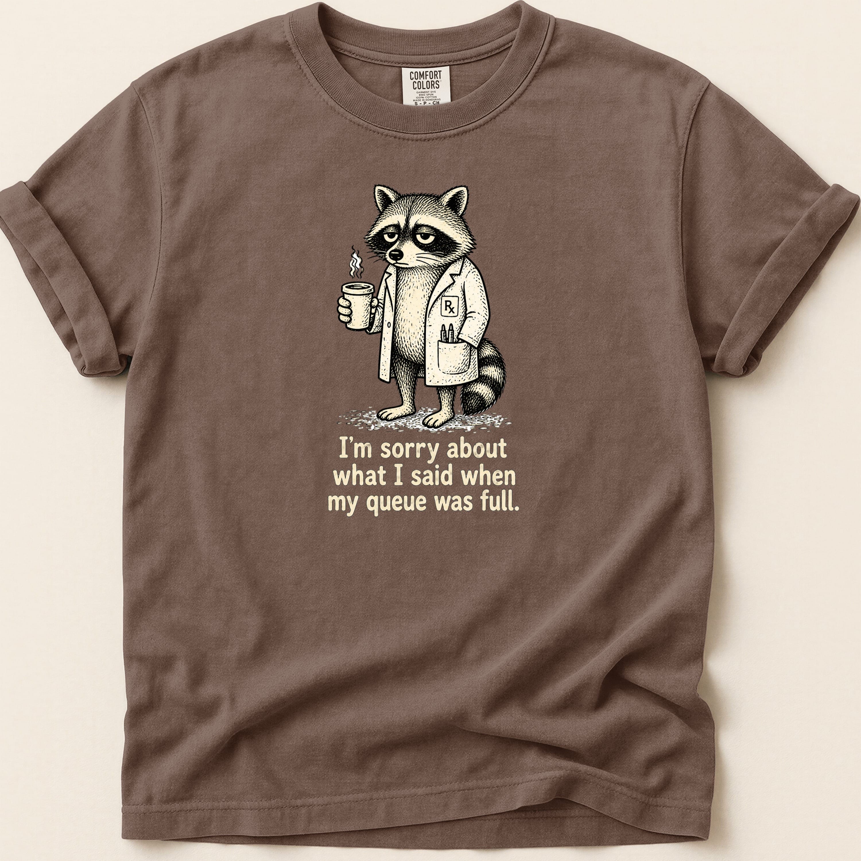 T-shirt with a raccoon in a lab coat holding coffee and text.