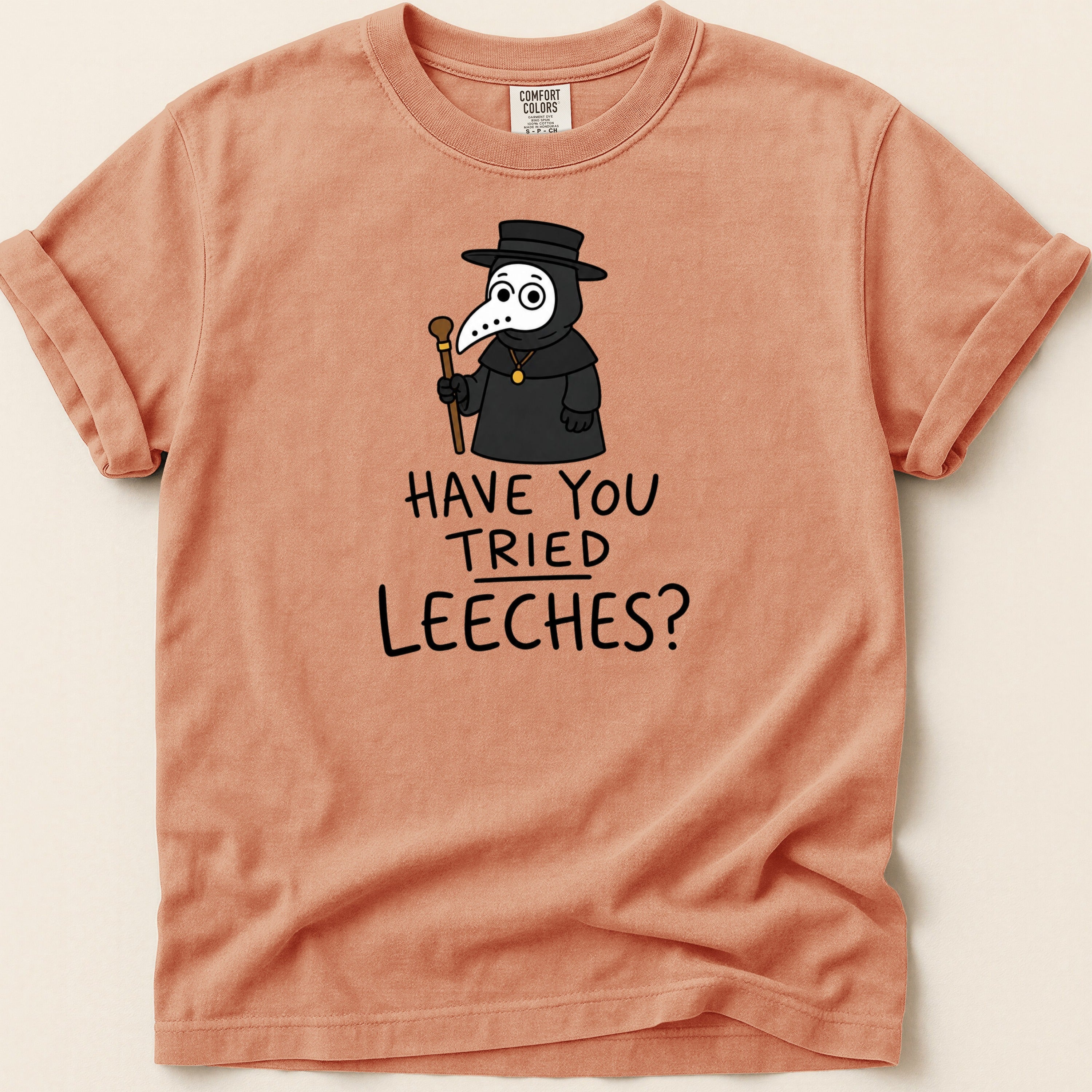 T-shirt with a cartoon plague doctor graphic and text "HAVE YOU TRIED LEECHES?".