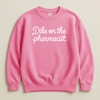 Pink sweatshirt with "Dibs on the pharmacist" text.