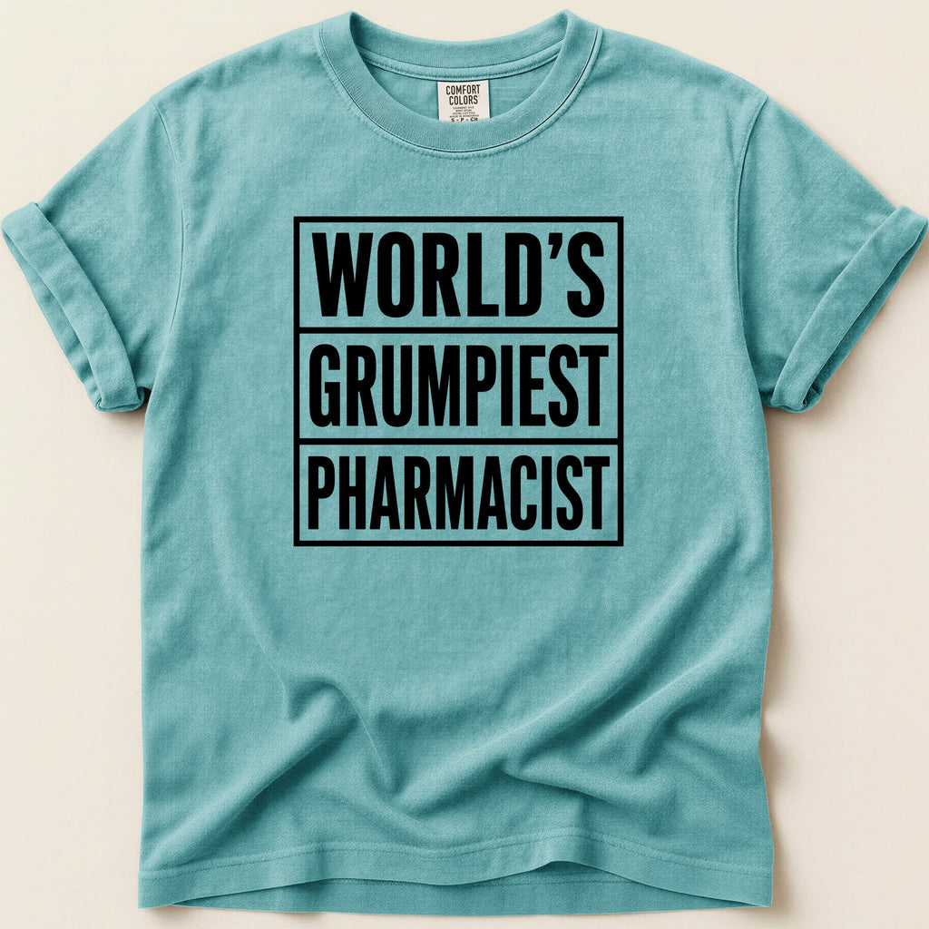 Teal t-shirt with black text "WORLD'S GRUMPIEST PHARMACIST".
