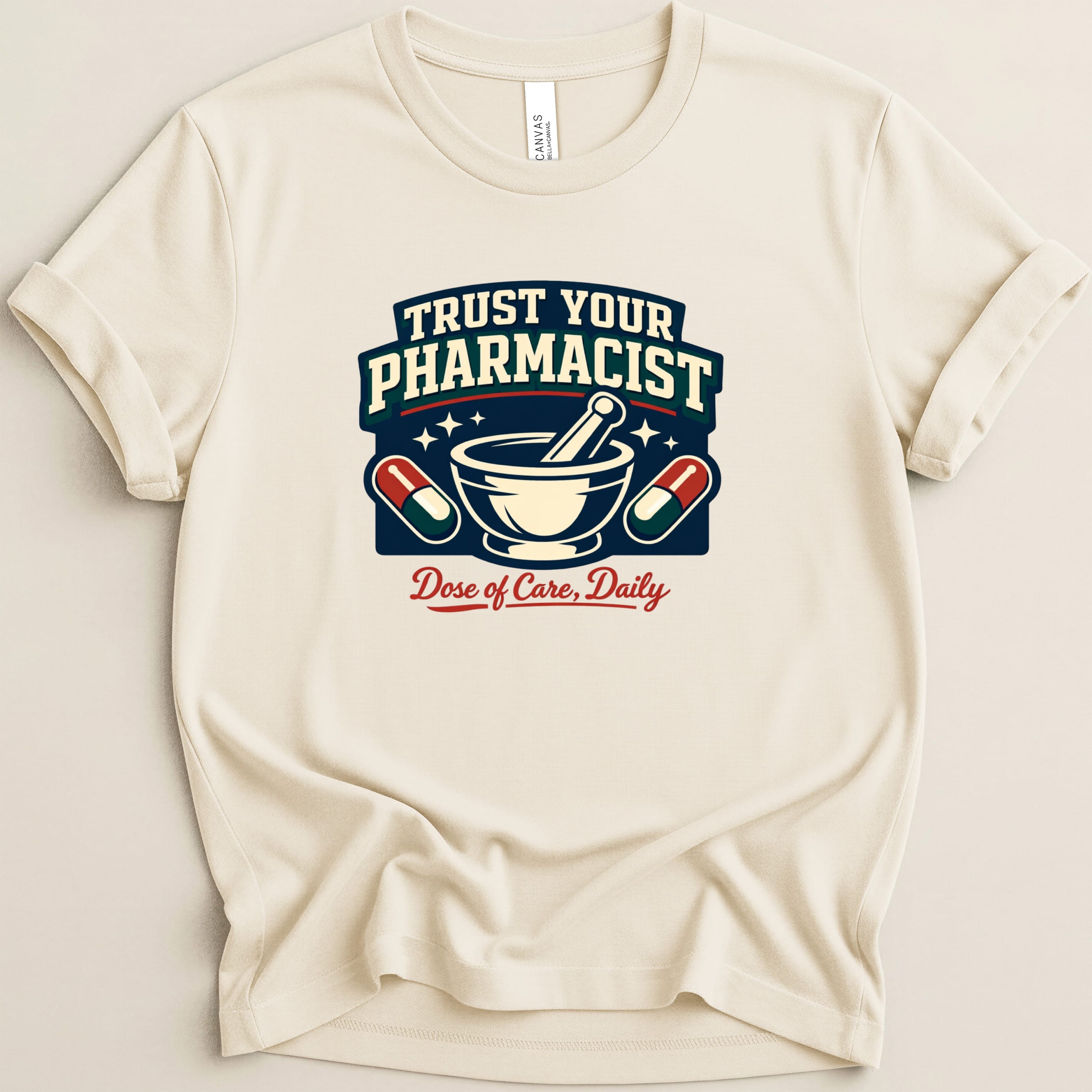 Cream t-shirt with "TRUST YOUR PHARMACIST Dose of Care, Daily" text and medical icons.