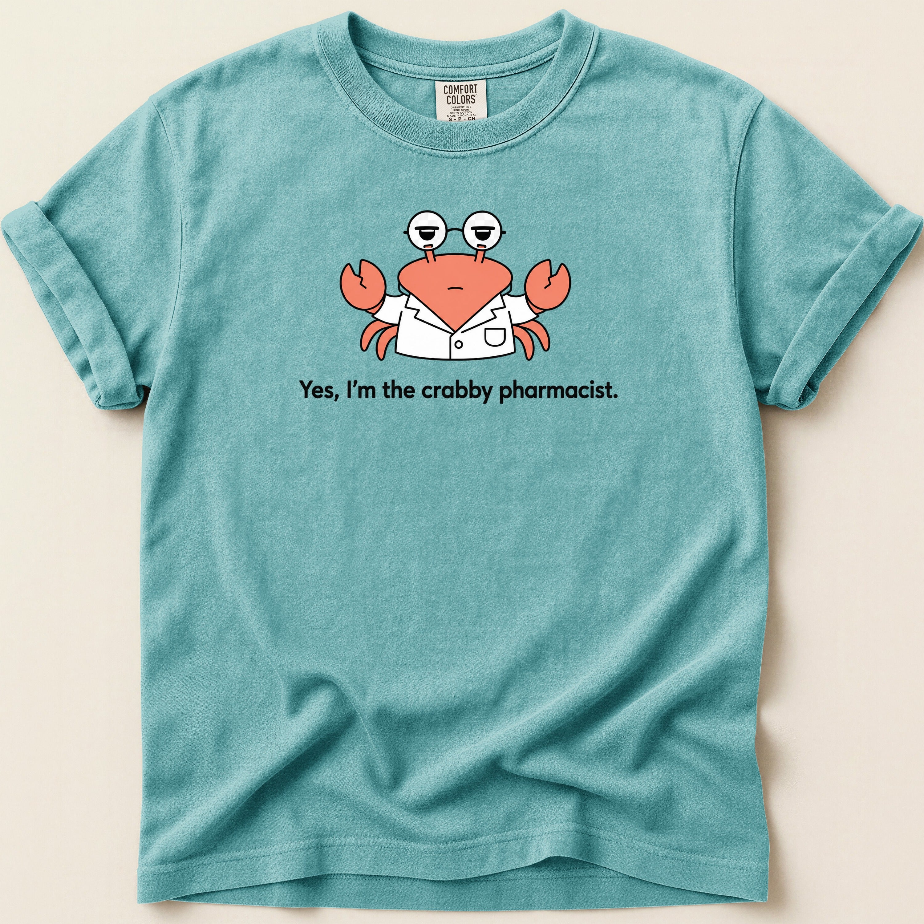 Blue t-shirt with cartoon crab in lab coat saying "Yes, I'm the crabby pharmacist."