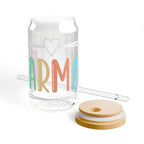 Clear glass can-shaped tumbler with "karma" text and straw.