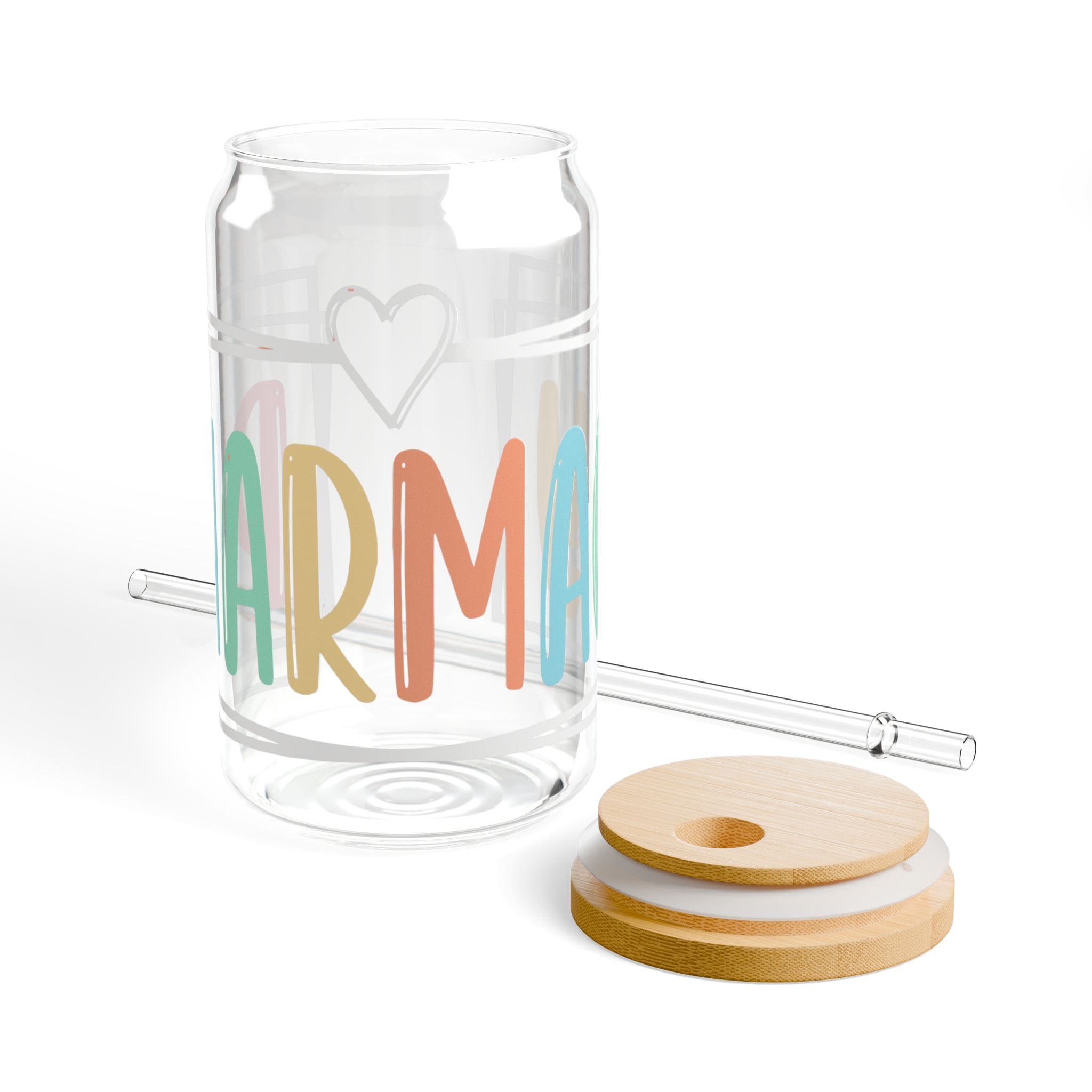 Clear glass can-shaped tumbler with "karma" text and straw.