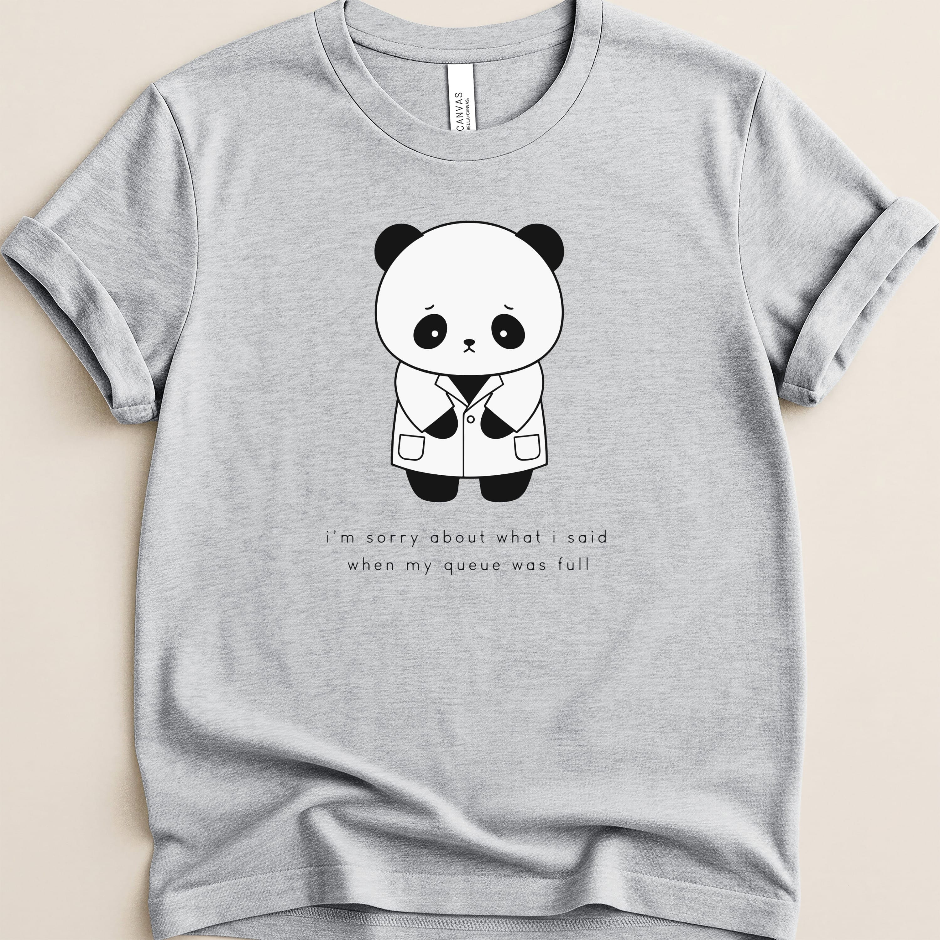 Light gray t-shirt with sad panda graphic and text about a full queue.