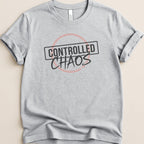 Grey t-shirt with "CONTROLLED CHAOS" text in a black box with a pink outline.