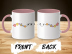 White mug with pink handle, featuring smiley faces and pharmacy-themed icons.