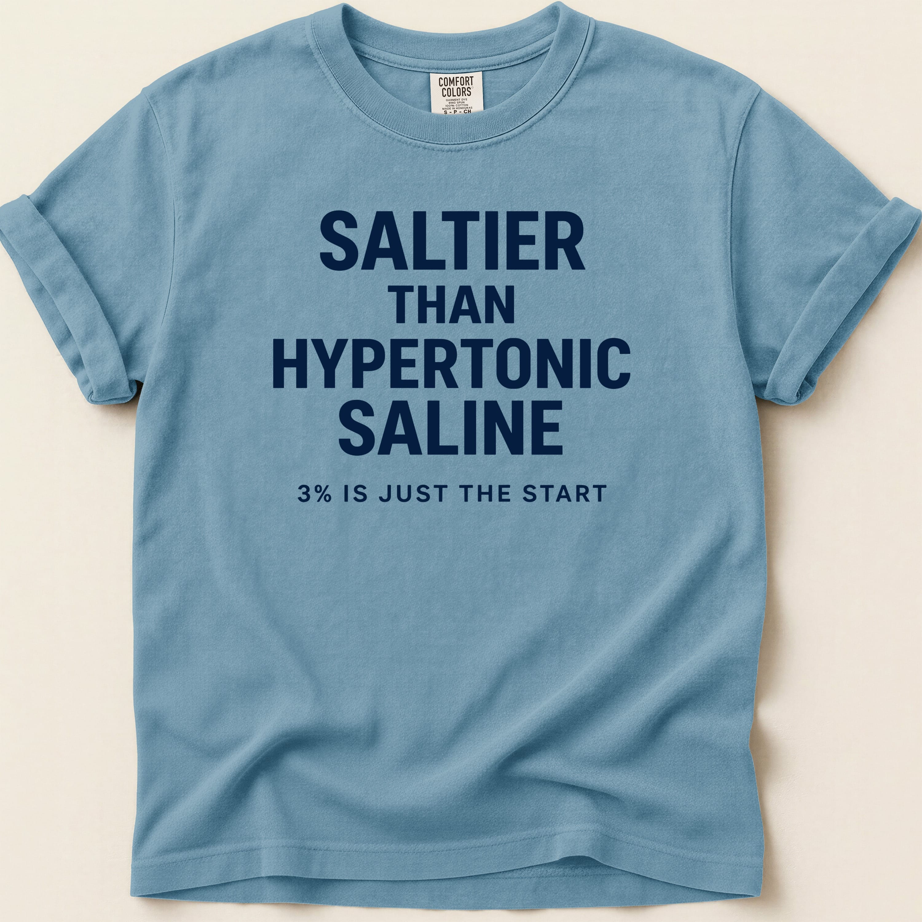 Blue t-shirt with "SALTIER THAN HYPERTONIC SALINE 3% IS JUST THE START" text.