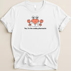 White t-shirt with a cartoon crab wearing glasses and a lab coat that says "Yes, I'm the crabby pharmacist."
