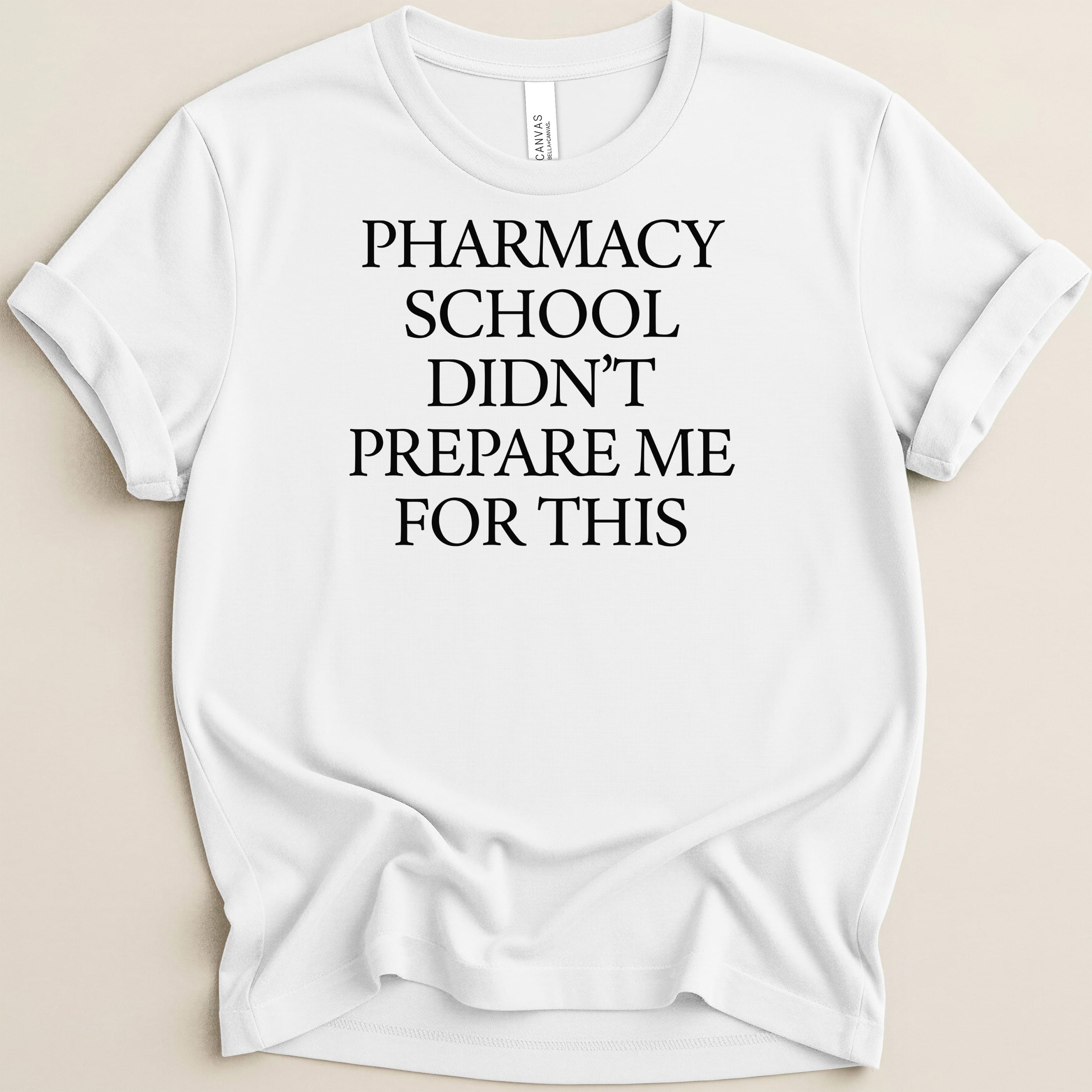 White t-shirt with black text: "PHARMACY SCHOOL DIDN'T PREPARE ME FOR THIS."
