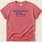 Red t-shirt with "FREEDOMCIN 1776 mg As Needed for Patriotism" text.