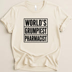 Cream t-shirt with "WORLD'S GRUMPIEST PHARMACIST" in black block letters.