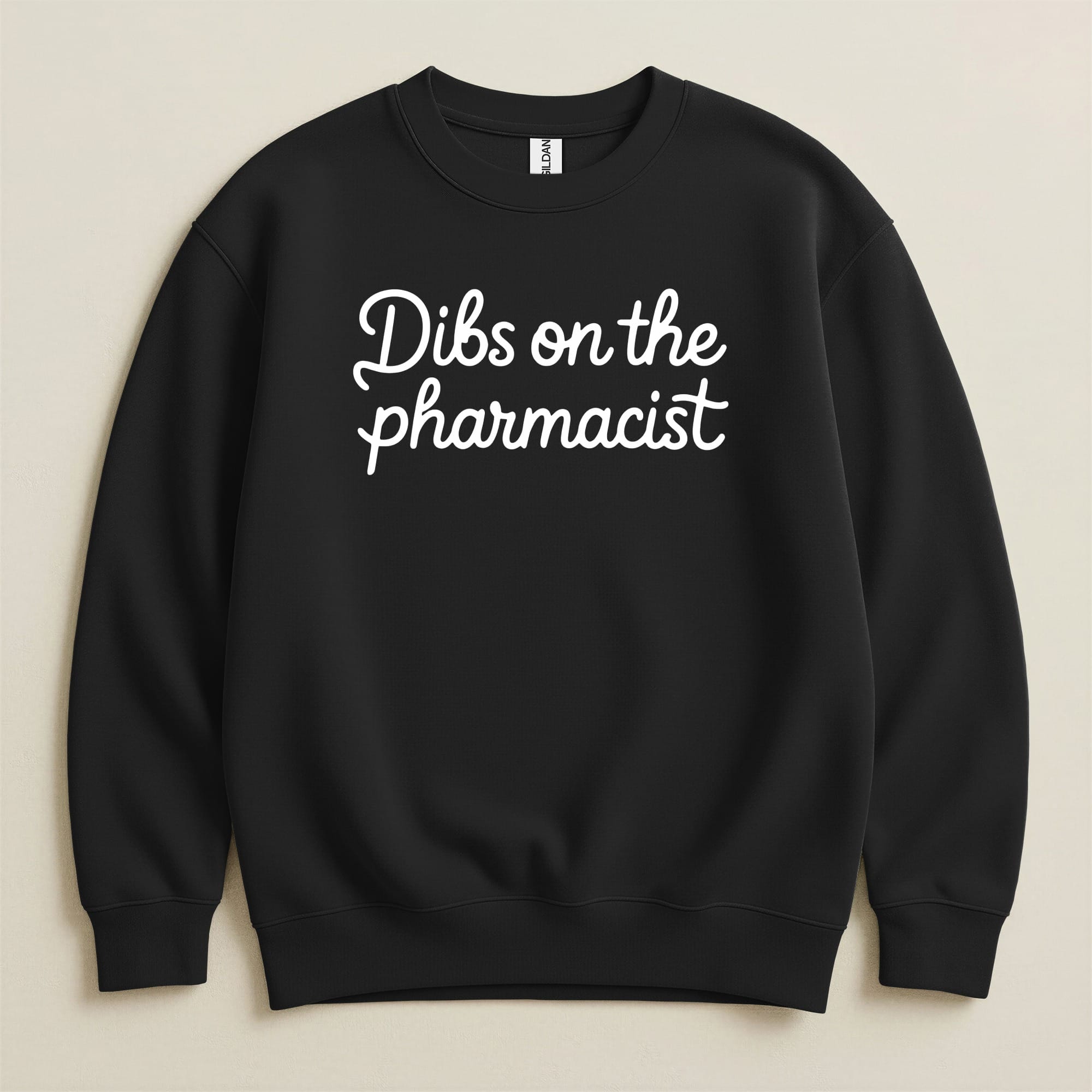 Black sweatshirt with white text that reads "Dibs on the pharmacist".