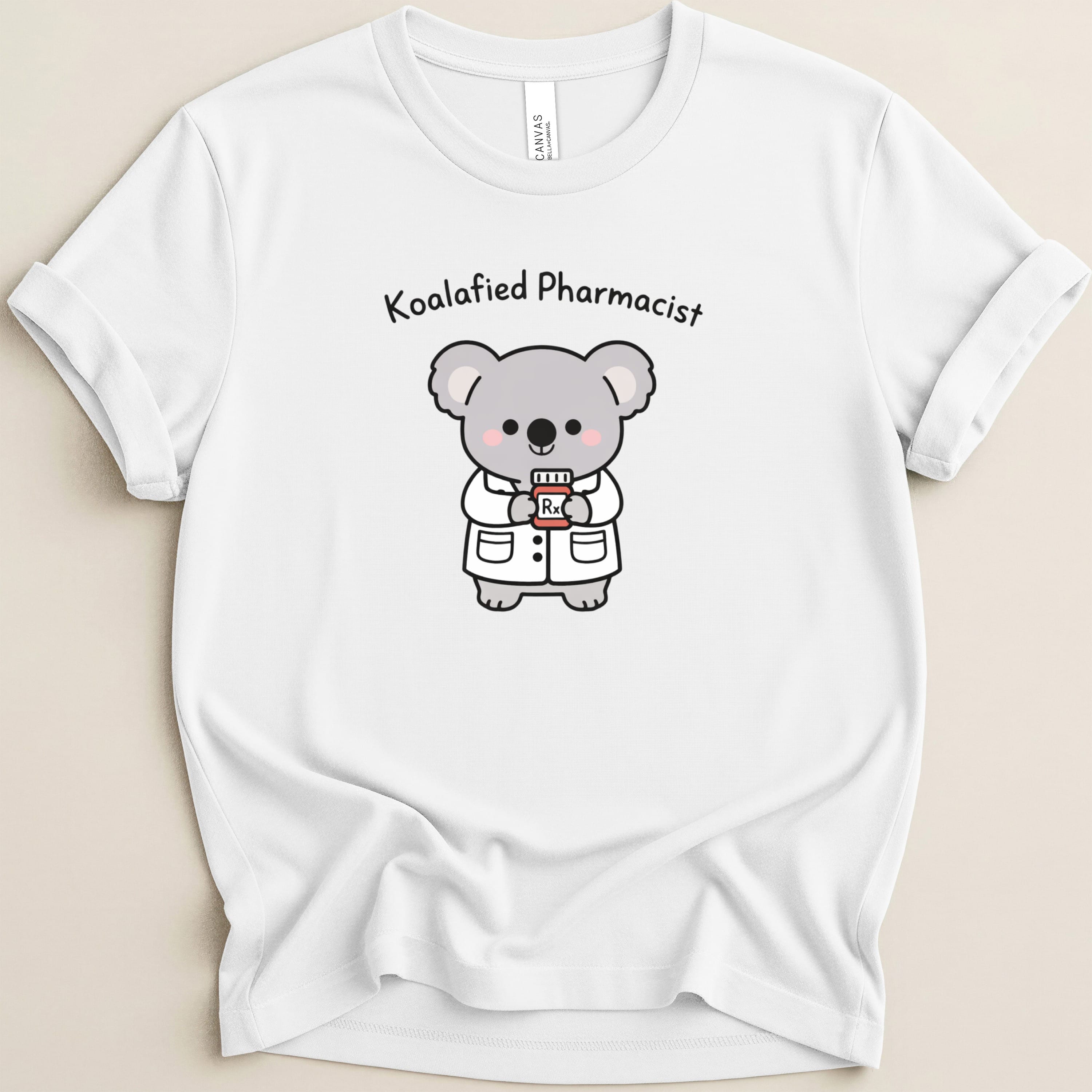 White t-shirt with cartoon koala pharmacist holding a prescription bottle.