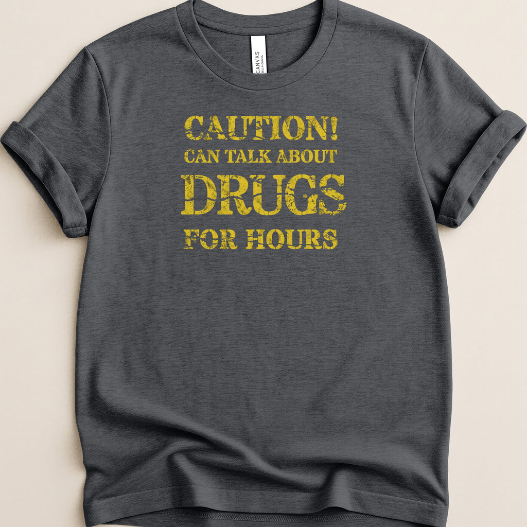 Dark grey t-shirt with yellow text: "CAUTION! CAN TALK ABOUT DRUGS FOR HOURS".