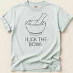 Light blue t-shirt with black line art of a mortar and pestle and text "I LICK THE BOWL".