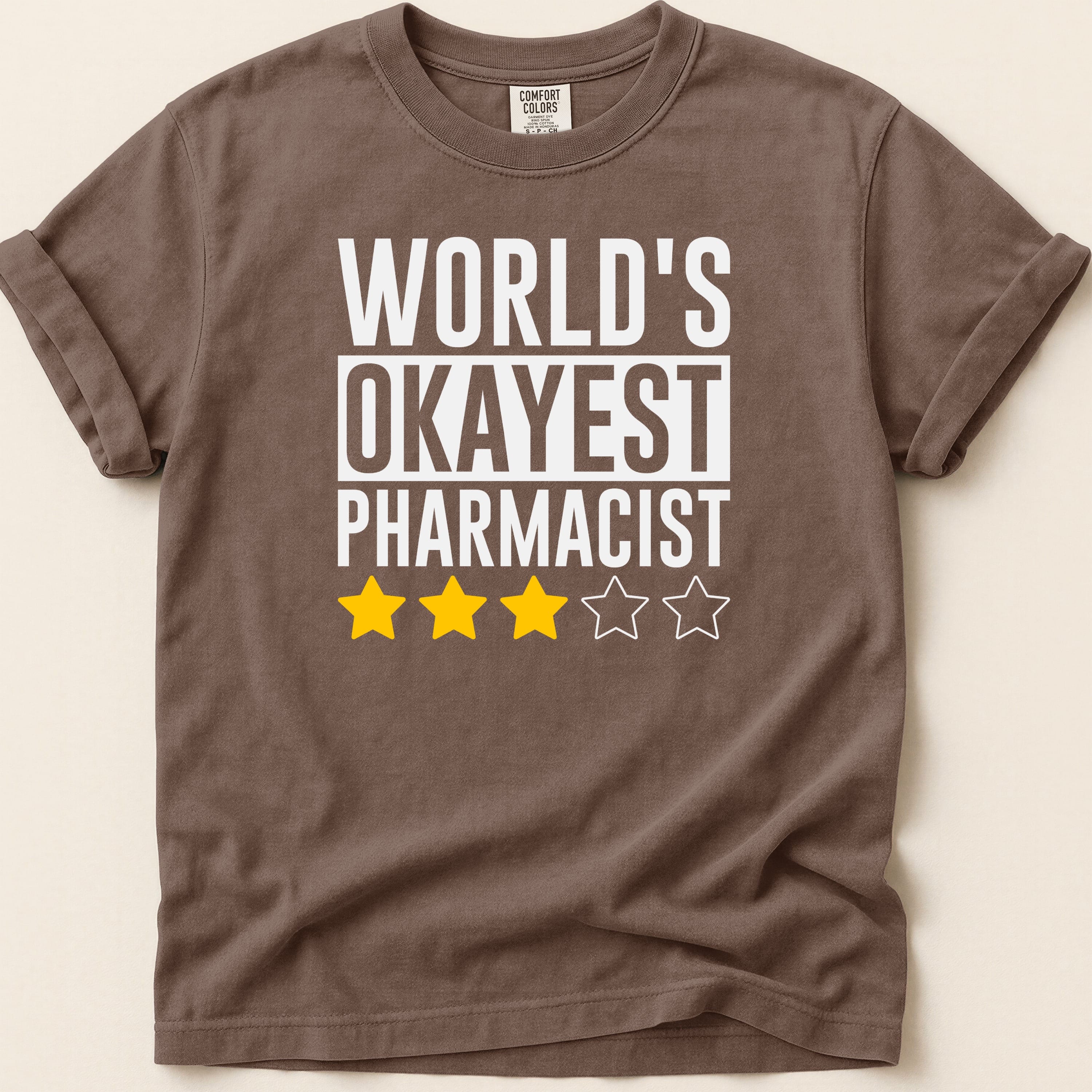 Brown t-shirt with "World's Okayest Pharmacist" and three star ratings.