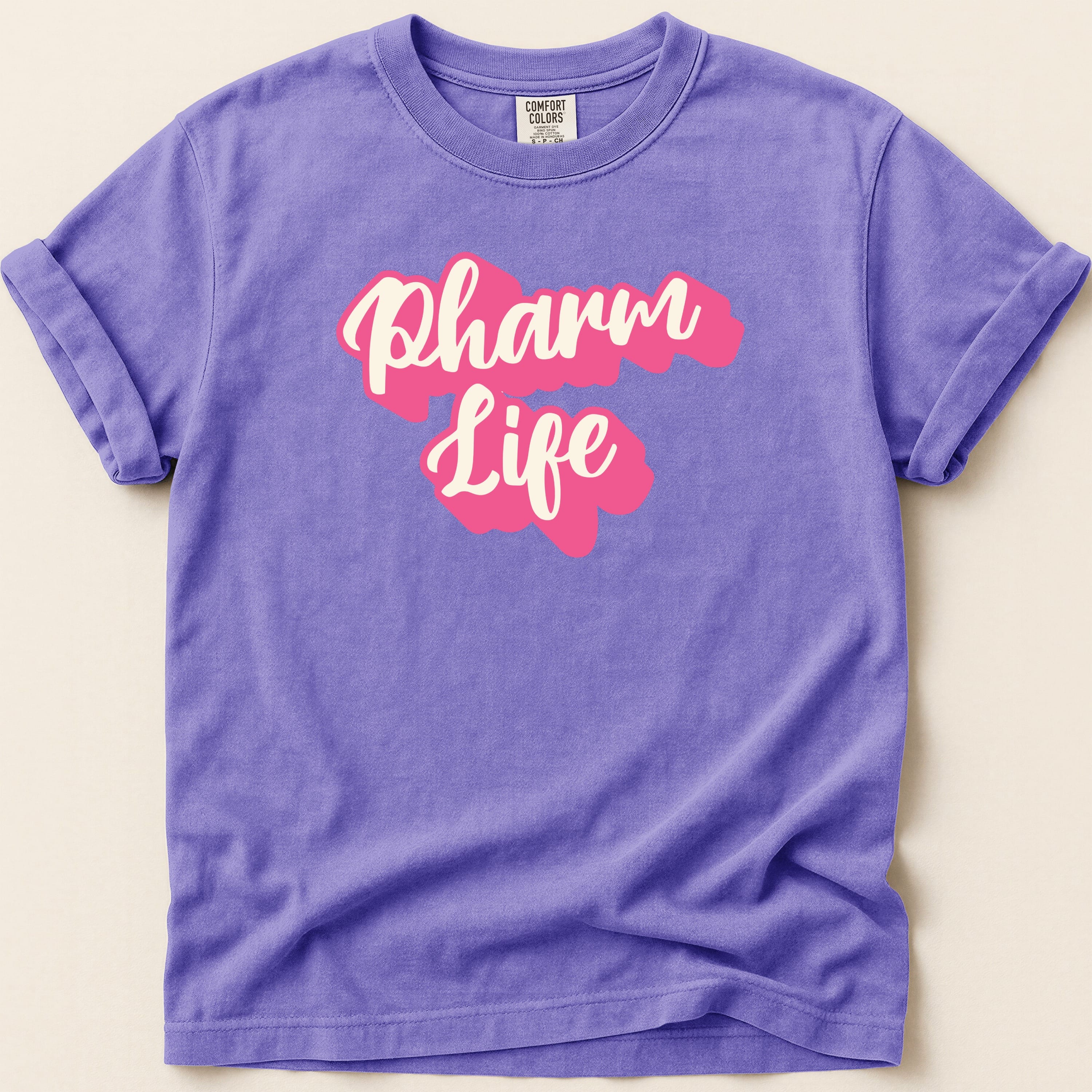 Purple t-shirt with "Pharm Life" in pink bubble lettering.