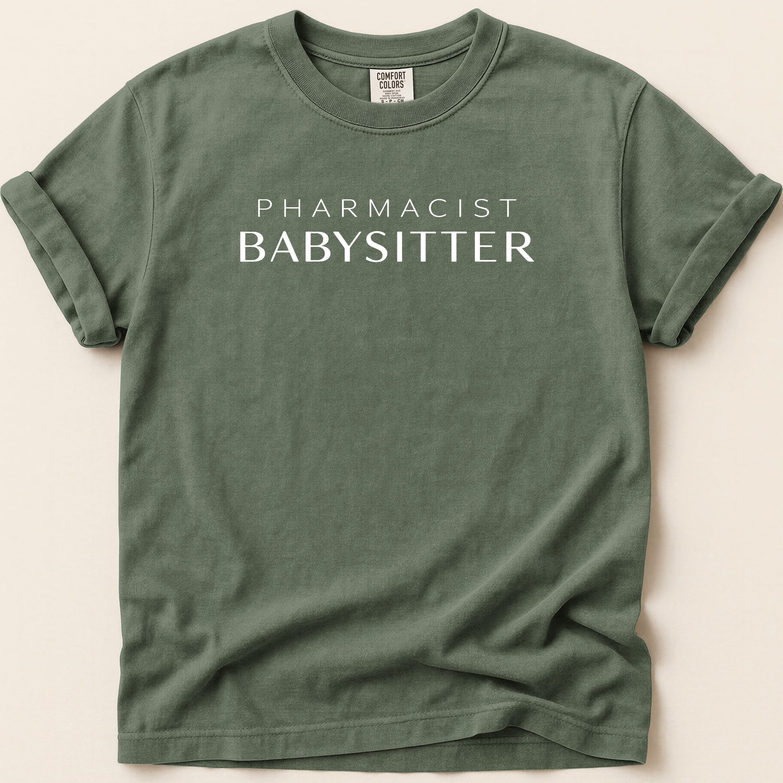Green t-shirt with white text "Pharmacist Babysitter".