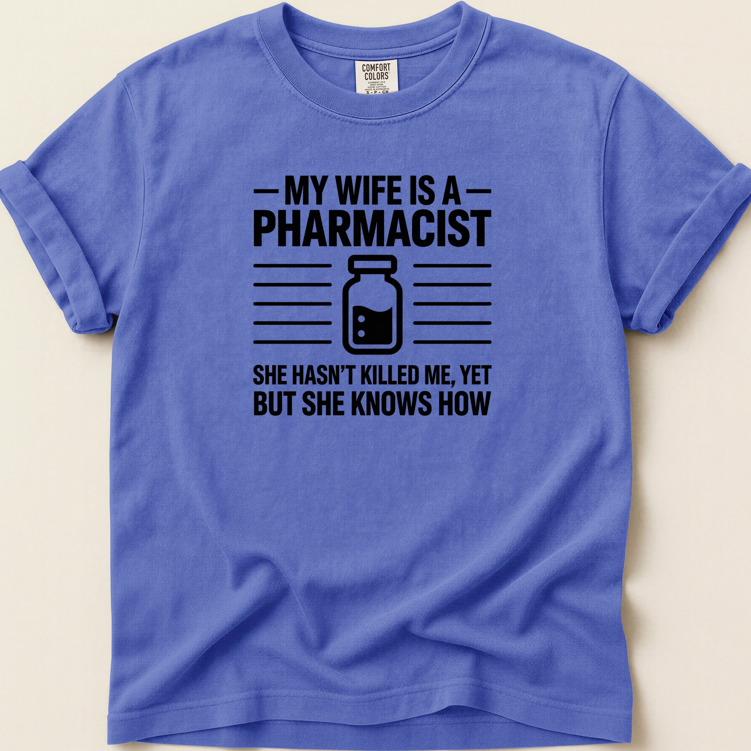 T-shirt with text "My wife is a pharmacist. She hasn't killed me, yet but she knows how."