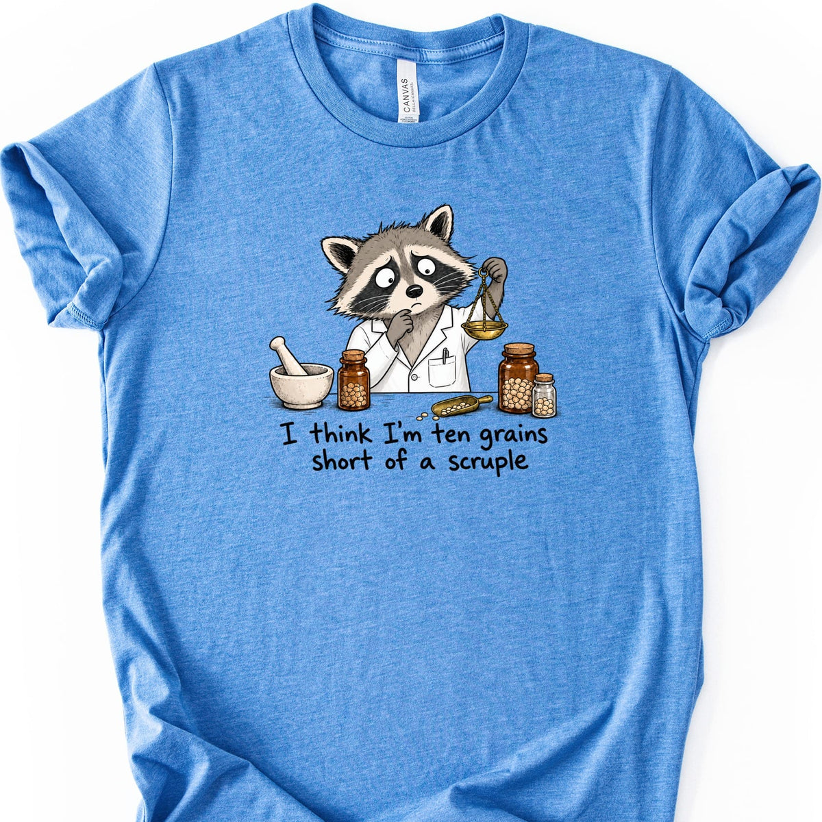 Raccoon in lab coat with scales and jars reads "I think I'm ten grains short of a scruple."