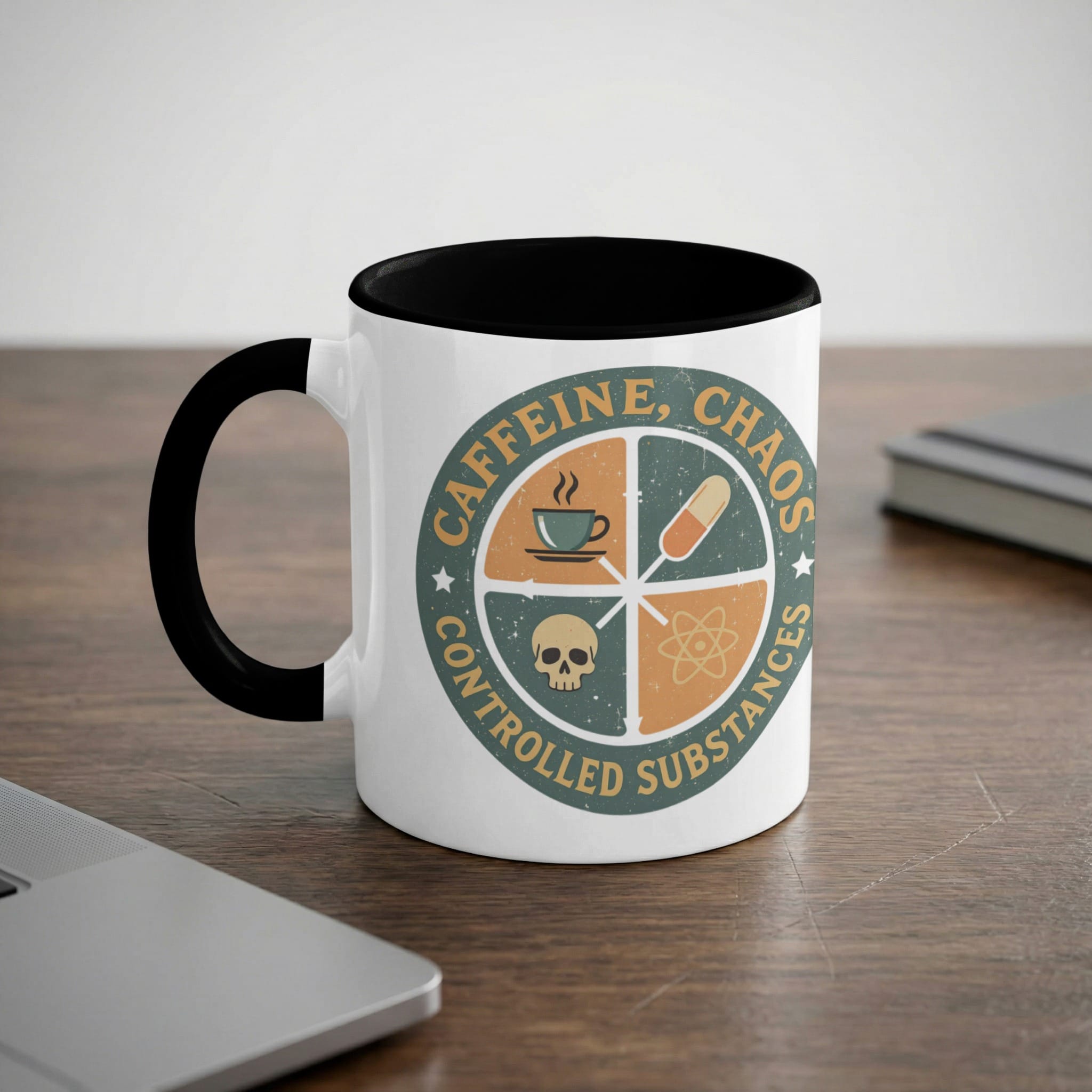 White mug with black rim and handle, featuring a circular logo with "CAFFEINE, CHAOS" text.