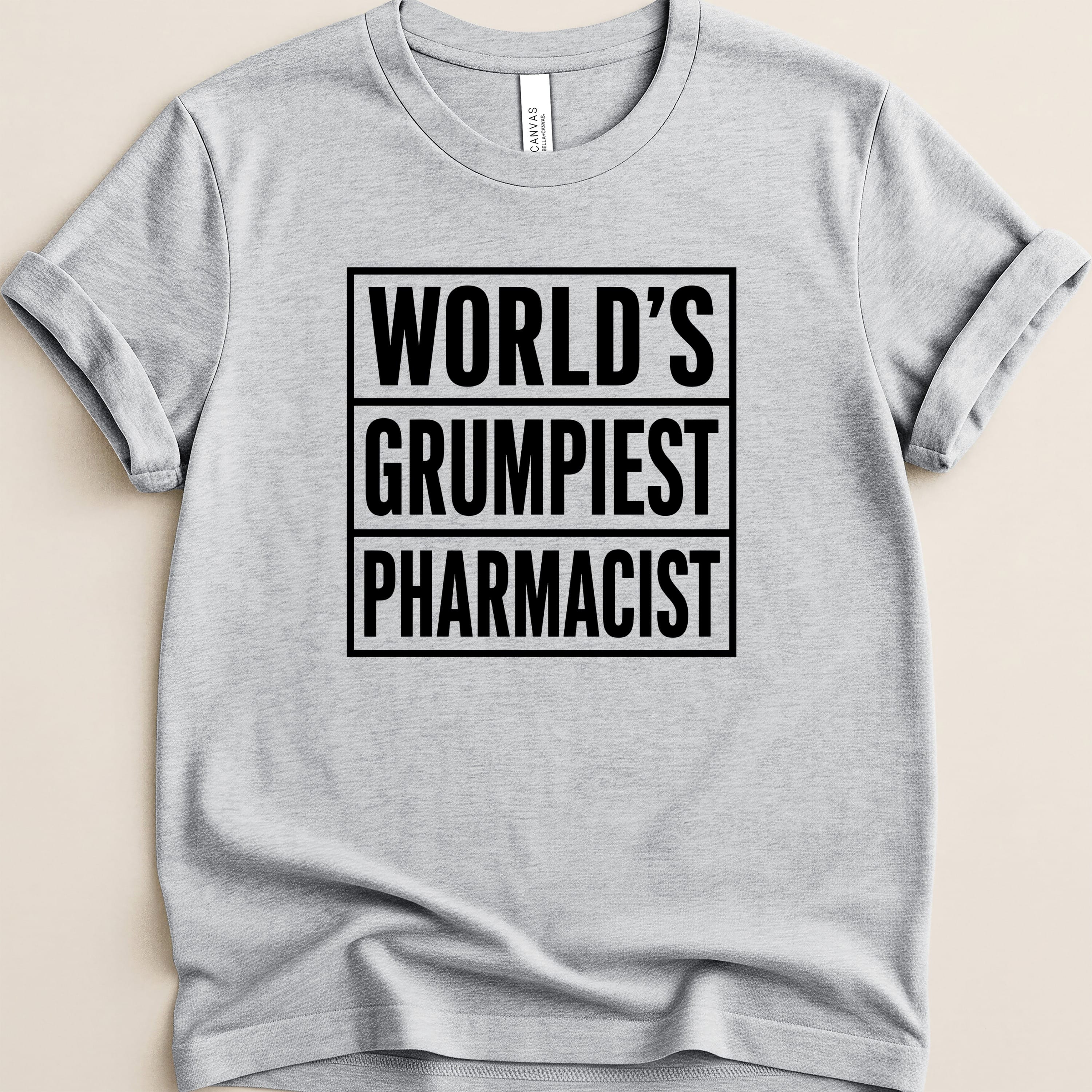 Gray t-shirt with "World's Grumpiest Pharmacist" in bold black text.